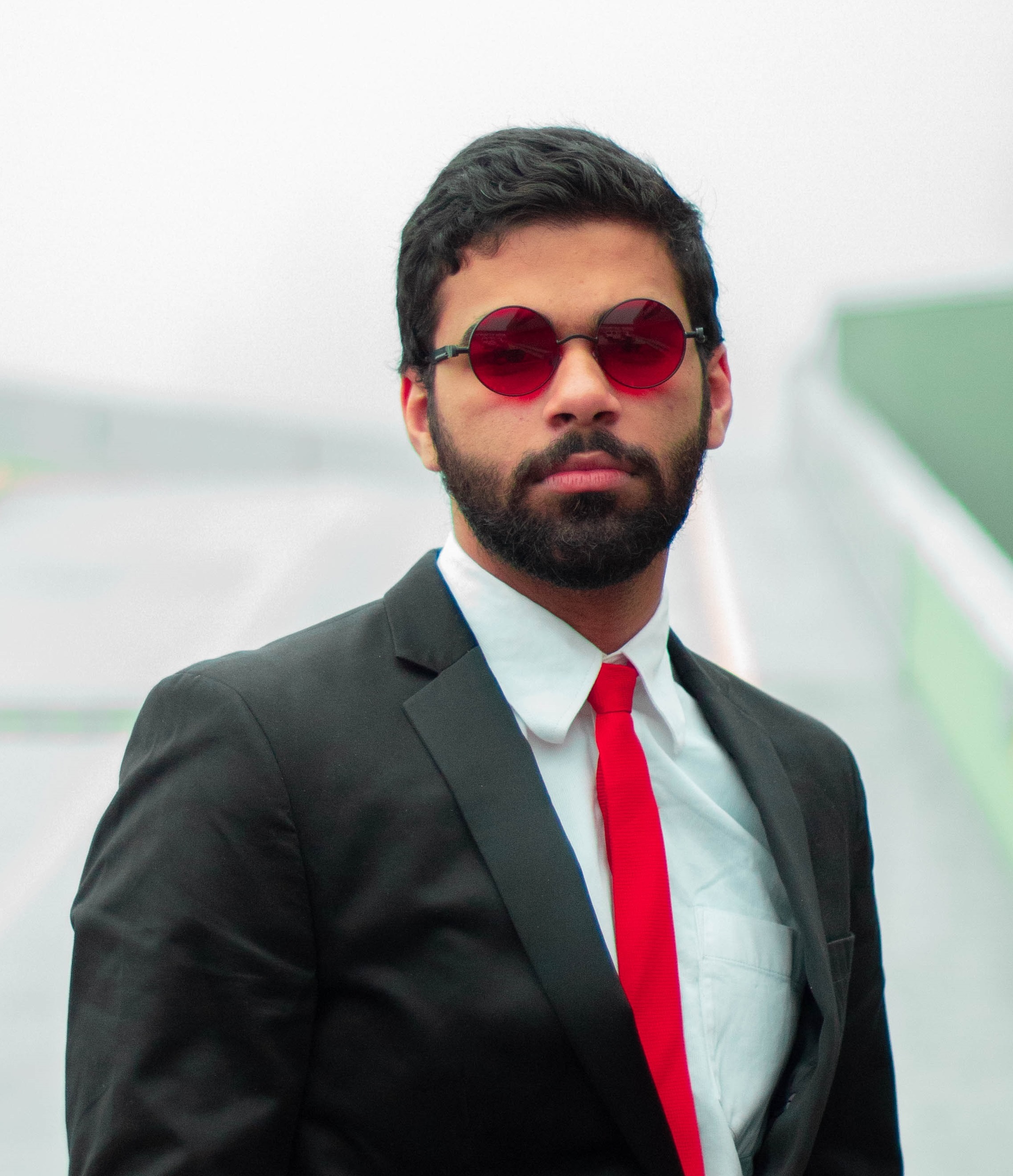 photo of the author Kanwarveer Sidhu in red tinted sunglasses 